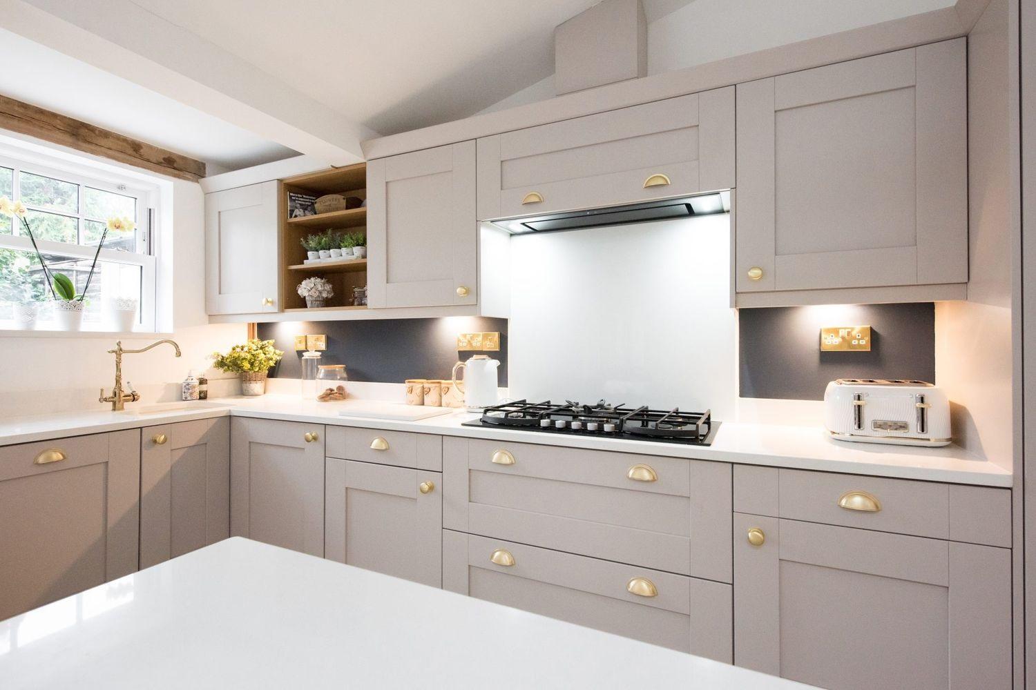 A kitchen with white cabinets and a stove Description automatically generated